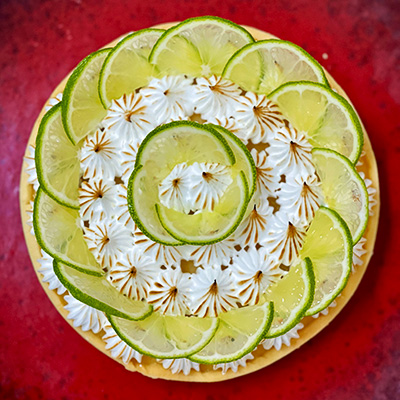 Lemon meringue pie decorated with lime