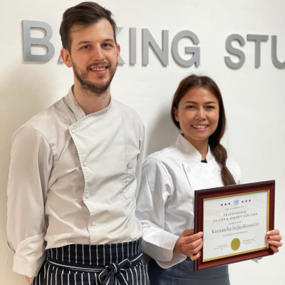Chef Lucas with a student holding her diploma