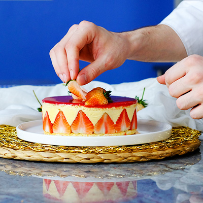 Chef Lucas decorating a strawberry cake