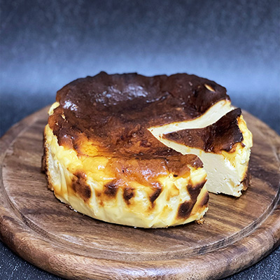 Basque cheesecake on a wooden tray